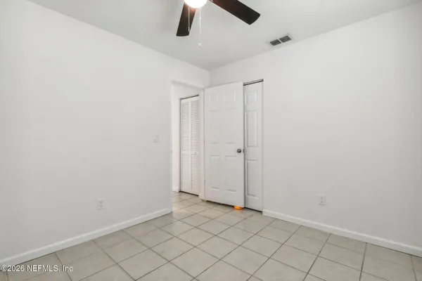 an empty room with ceiling fan