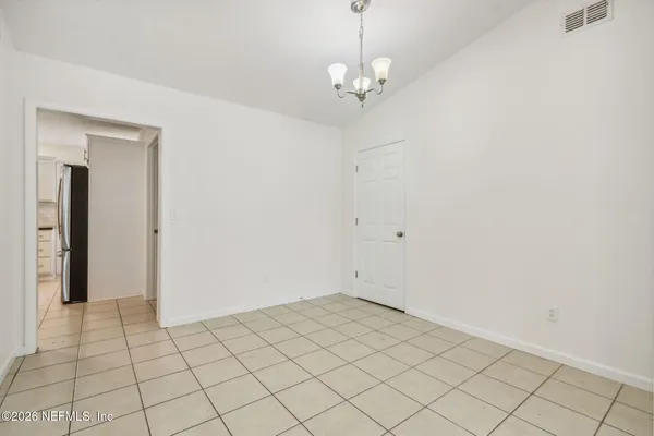 a kitchen with granite countertop white cabinets stainless steel appliances a sink and a window