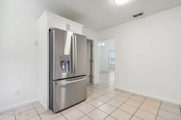 an empty room with closet and windows