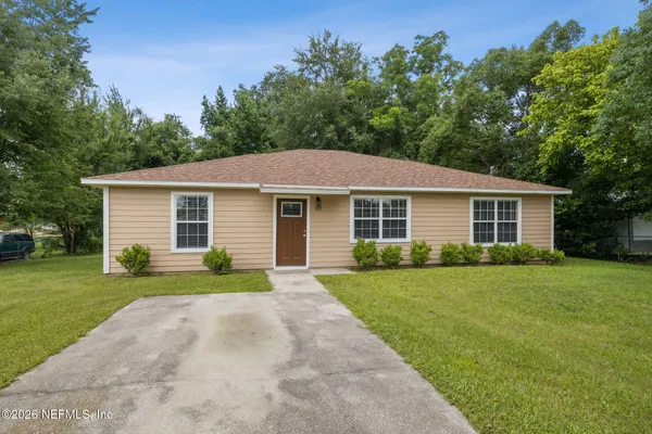 a front view of a house with a yard