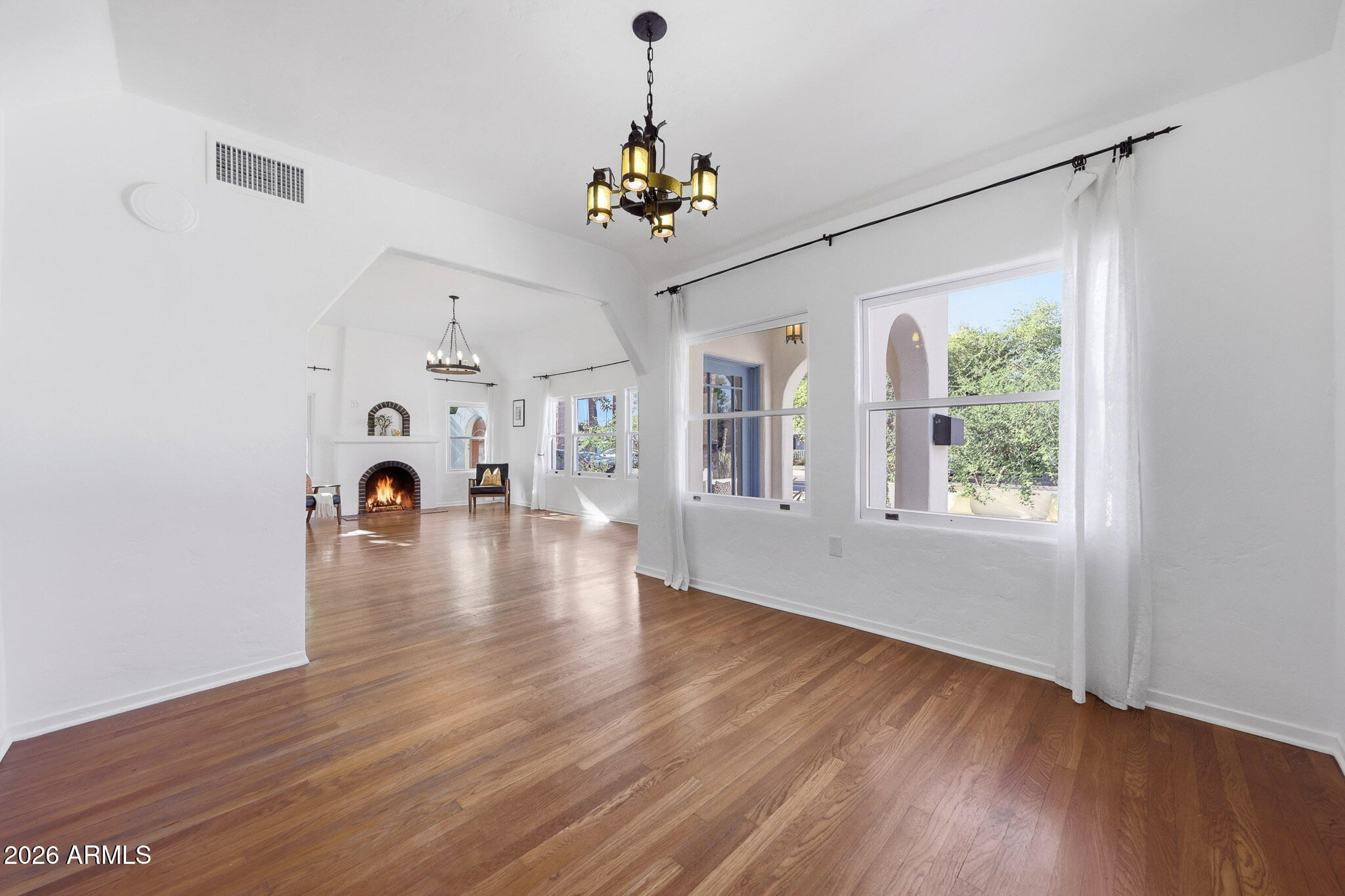 1555 East Cheery Lynn Road Phoenix, AZ 85014 - Photo 11 of 37 a view of a room with wooden floor chandelier and windows