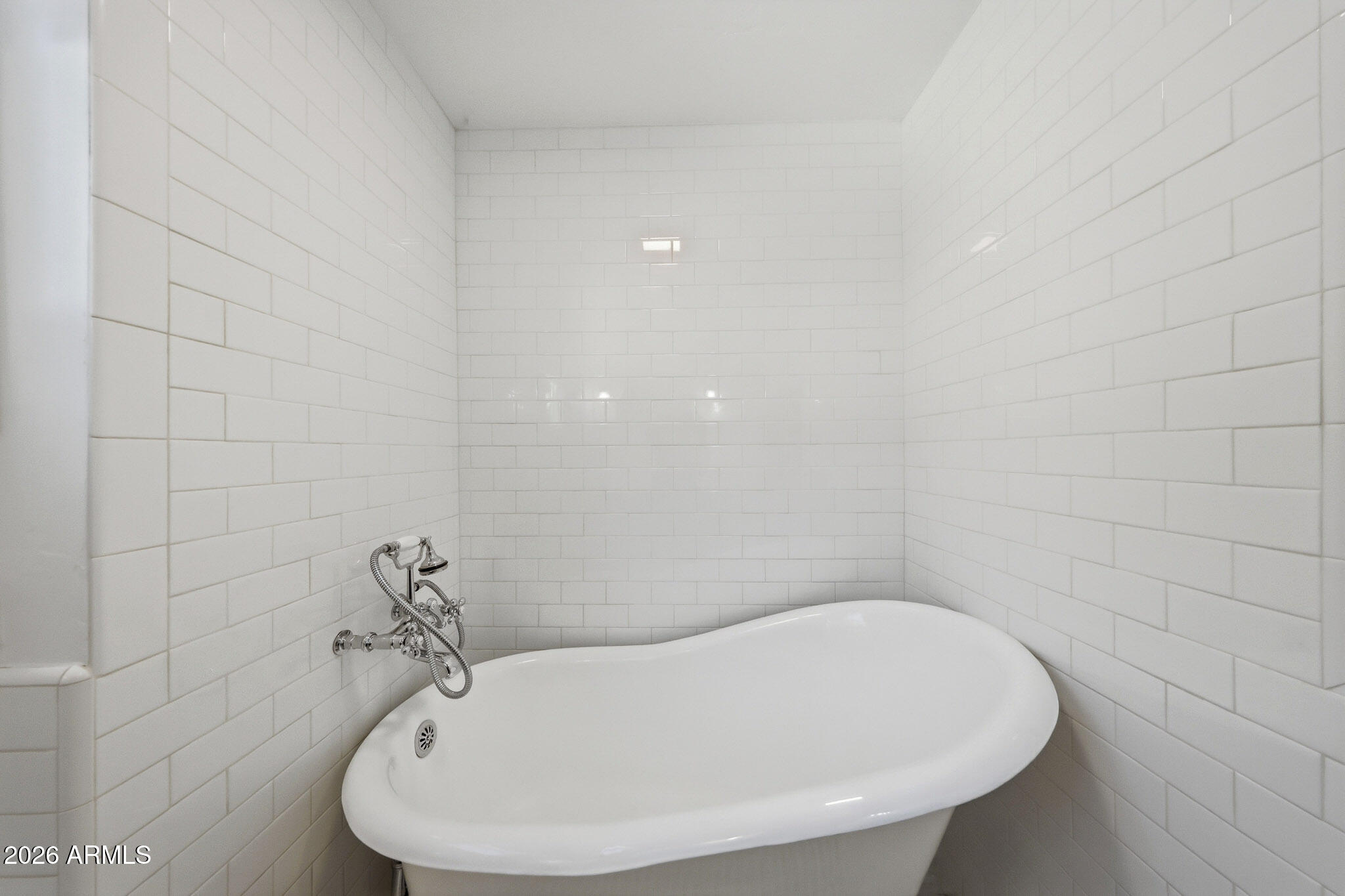 1555 East Cheery Lynn Road Phoenix, AZ 85014 - Photo 16 of 37 a bathroom with a white bath tub and a sink