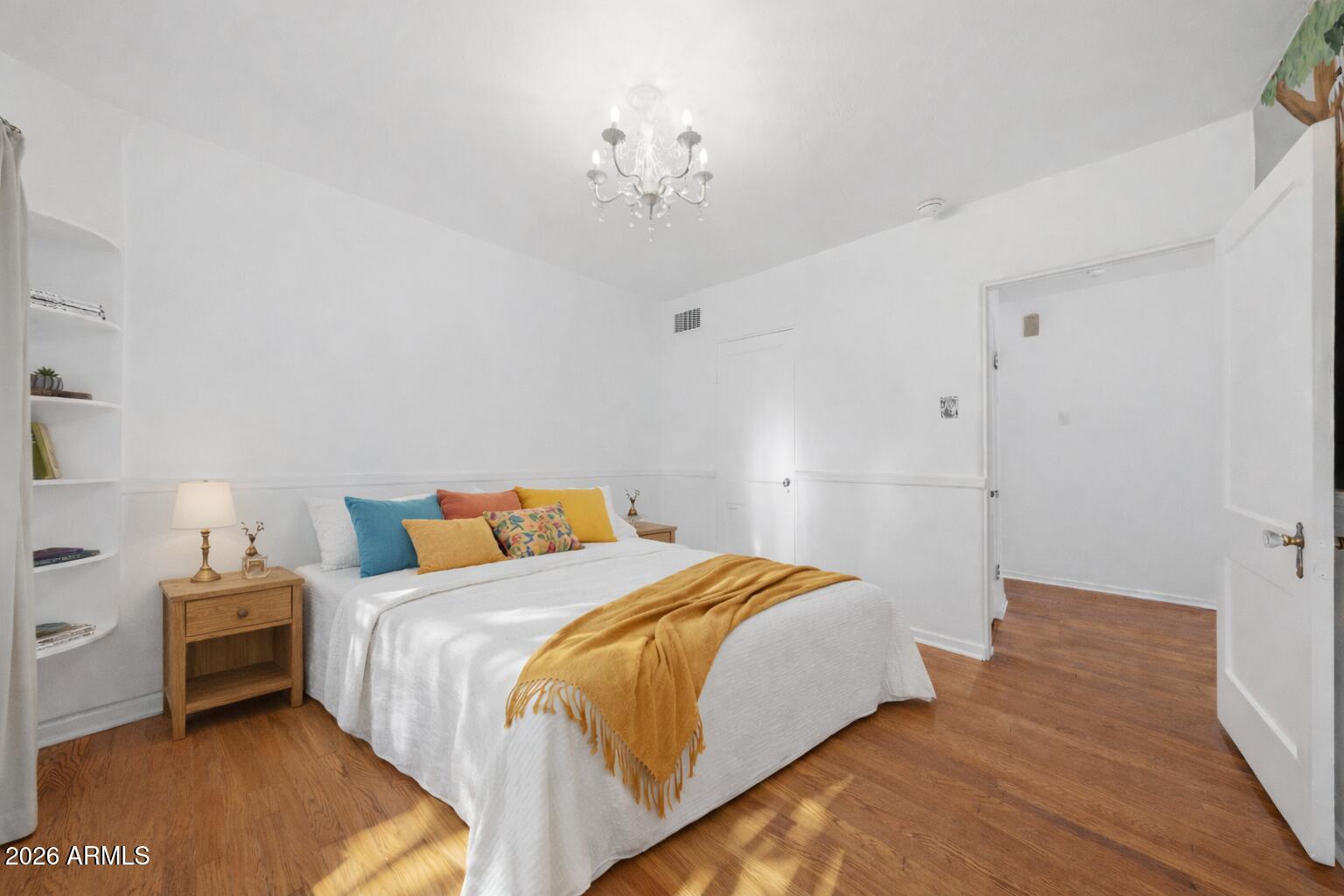 1555 East Cheery Lynn Road Phoenix, AZ 85014 - Photo 19 of 37 a bedroom with a bed and a chandelier