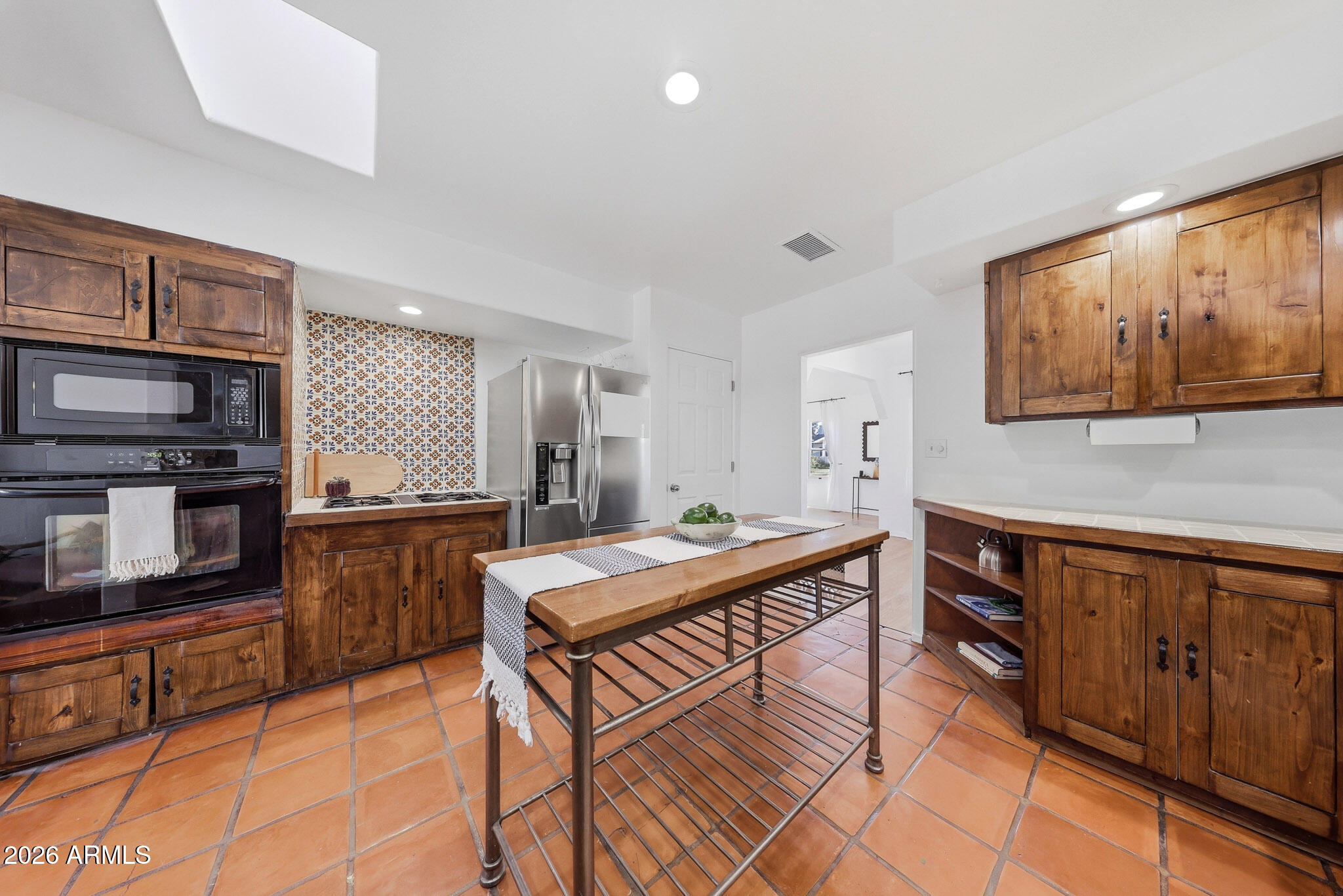 1555 East Cheery Lynn Road Phoenix, AZ 85014 - Photo 22 of 37 a kitchen with stainless steel appliances granite countertop a stove top oven a sink dishwasher and cabinets with wooden floor