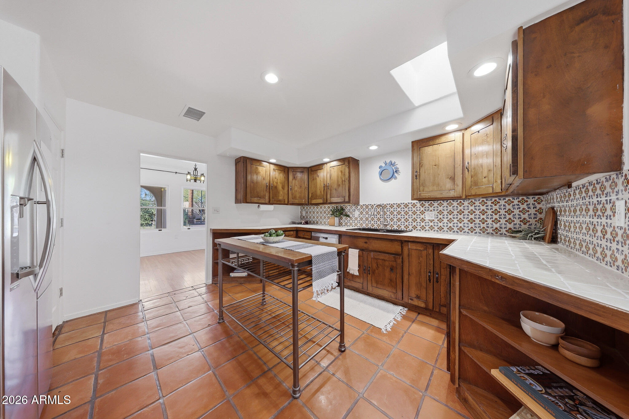 1555 East Cheery Lynn Road Phoenix, AZ 85014 - Photo 23 of 37 a kitchen with stainless steel appliances granite countertop a sink and cabinets