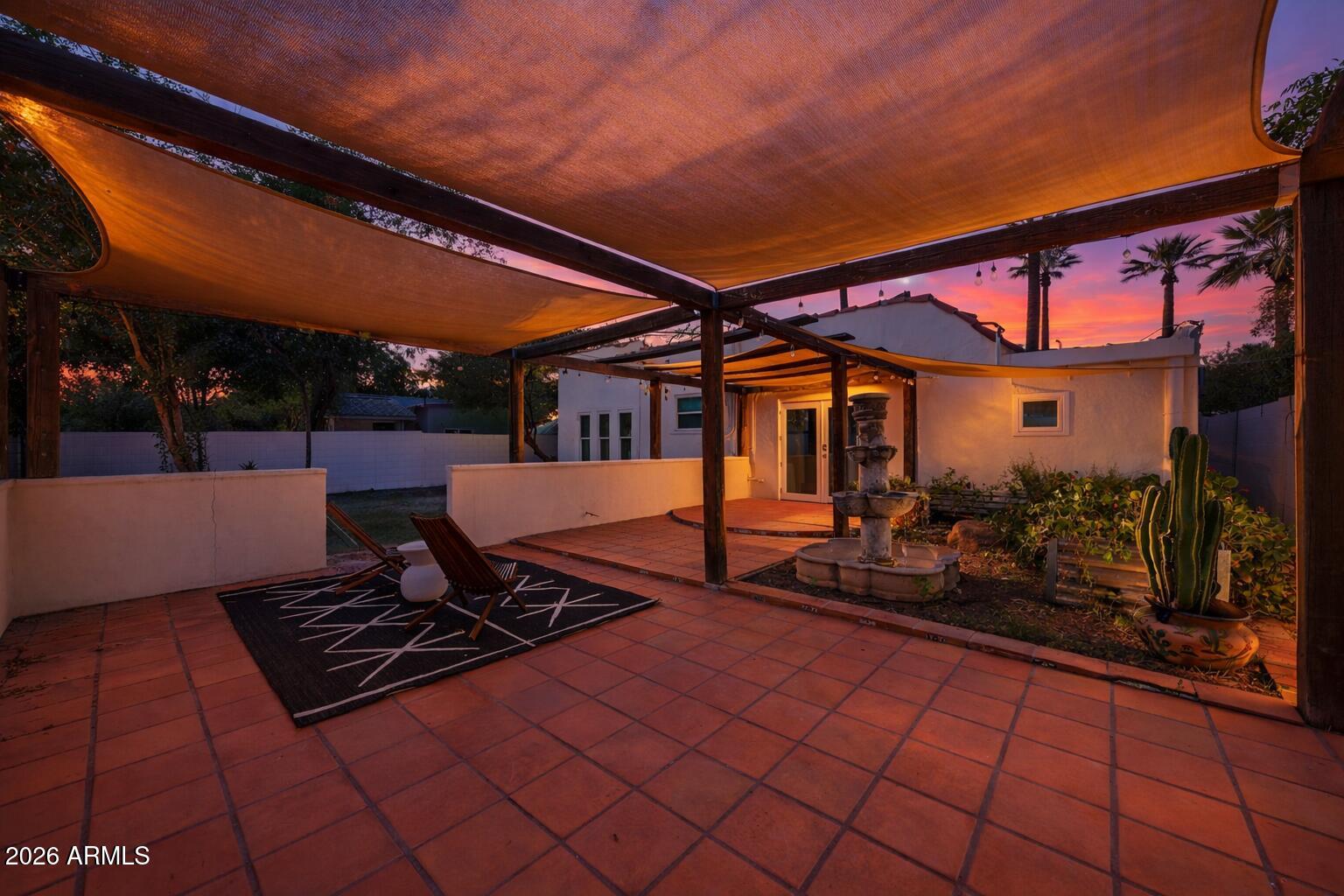 1555 East Cheery Lynn Road Phoenix, AZ 85014 - Photo 36 of 37 a view of a patio with table and chairs with wooden floor and fence