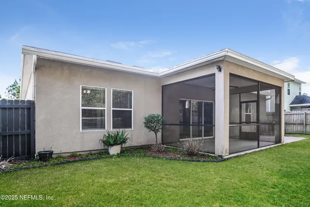 a view of a house with backyard and porch
