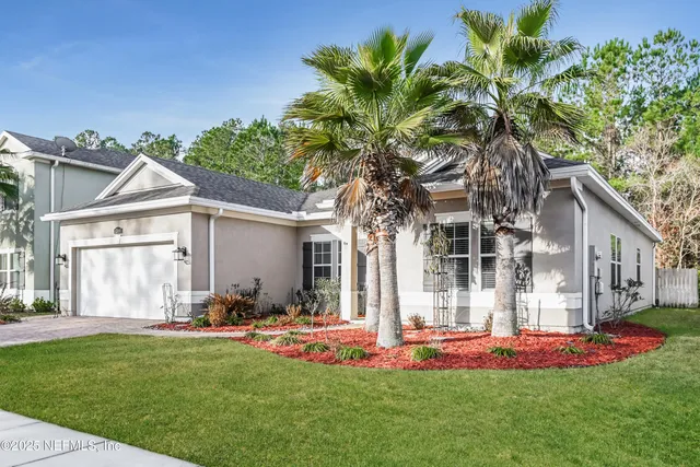 a front view of house with yard and green space