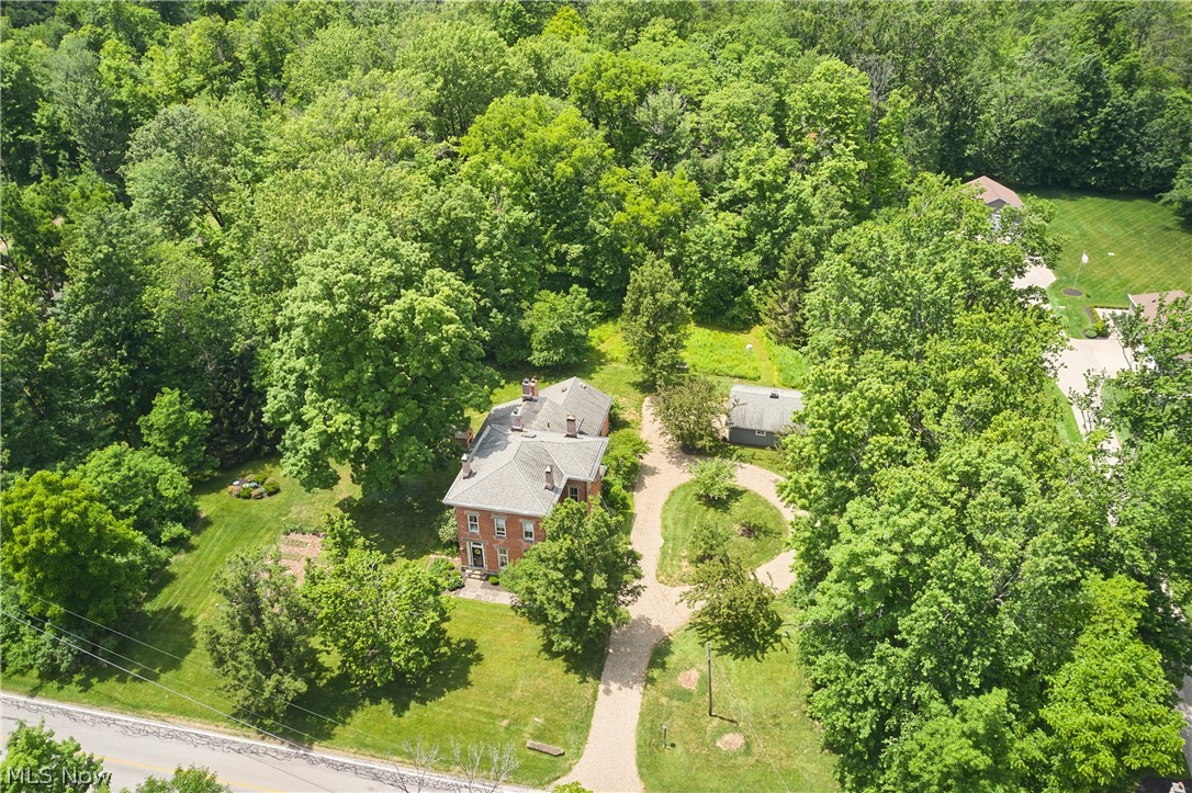 5046 Alger Road Richfield, OH 44286 - Photo 49 of 49 Brick residence surrounded by mature trees, featuring a gabled roofline and multiple chimneys