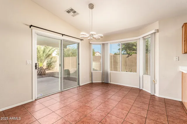 a view of a kitchen with kitchen island a sink a counter top space stainless steel appliances and cabinets