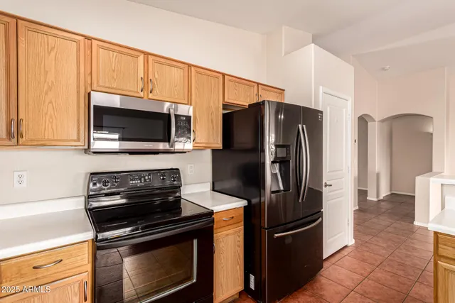 a view of a kitchen with a sink a window and chairs