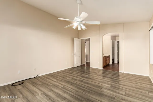 a spacious bathroom with double vanity and a mirror