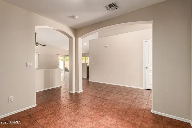a view of an empty room with glass door