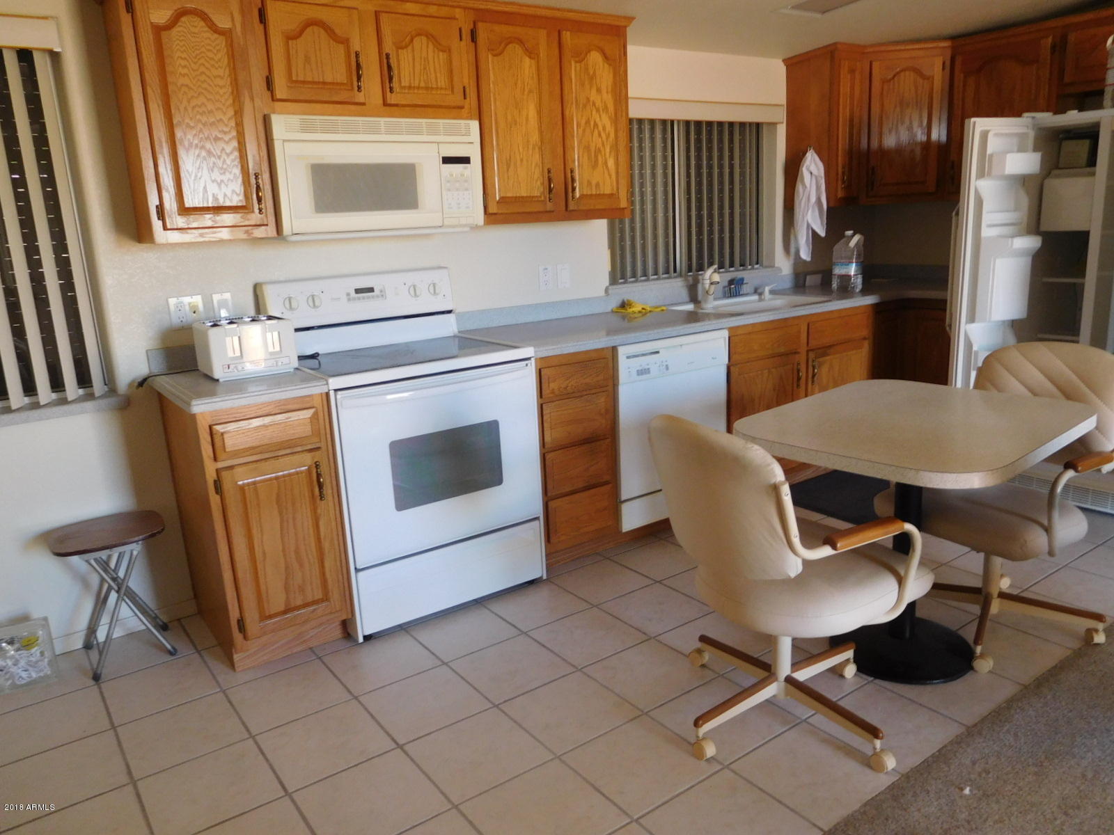 17200 West Bell Road, Unit 789 Surprise, AZ 85374 - Photo 2 of 9 a kitchen with stainless steel appliances a stove a sink and a refrigerator