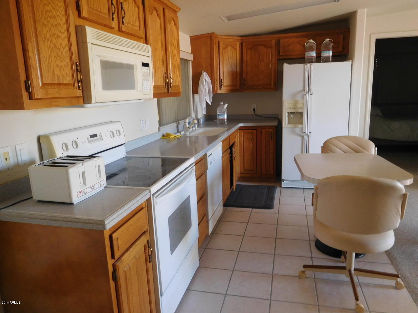 17200 West Bell Road, Unit 789 Surprise, AZ 85374 - Photo 3 of 9 a kitchen with a refrigerator sink and cabinets