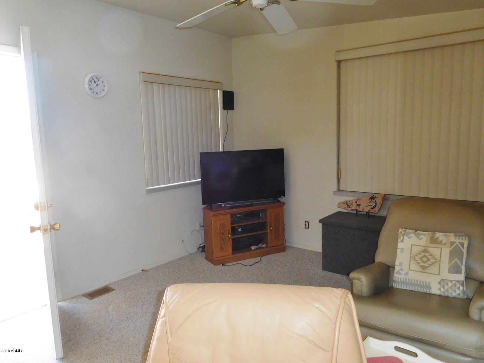 17200 West Bell Road, Unit 789 Surprise, AZ 85374 - Photo 5 of 9 a bedroom with a bed and a television