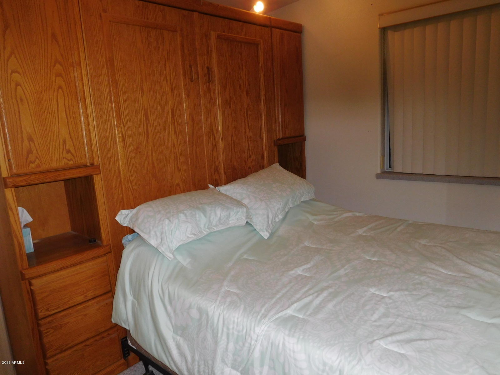 17200 West Bell Road, Unit 789 Surprise, AZ 85374 - Photo 7 of 9 a bedroom with a bed and cabinets