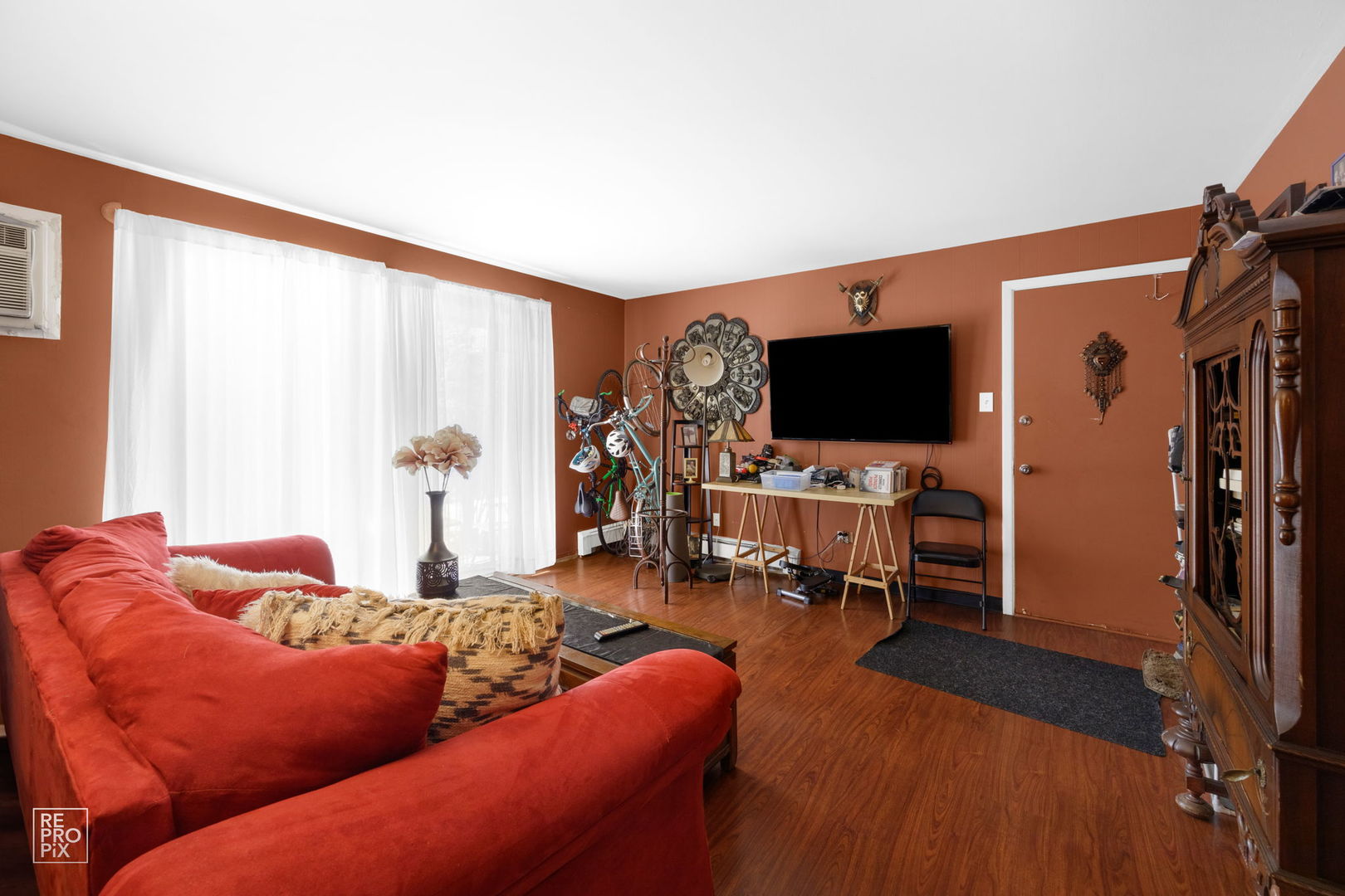 10300 Ridgeland Avenue, Unit 104 Chicago Ridge, IL 60415 - Photo 3 of 11 a living room with furniture and a flat screen tv