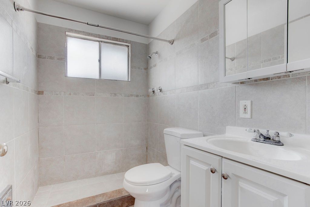 421 North Decatur Boulevard, Unit 2 Las Vegas, NV 89107 - Photo 12 of 21 Functional full bathroom with tiled shower stall and vanity sink, ready for daily routines.