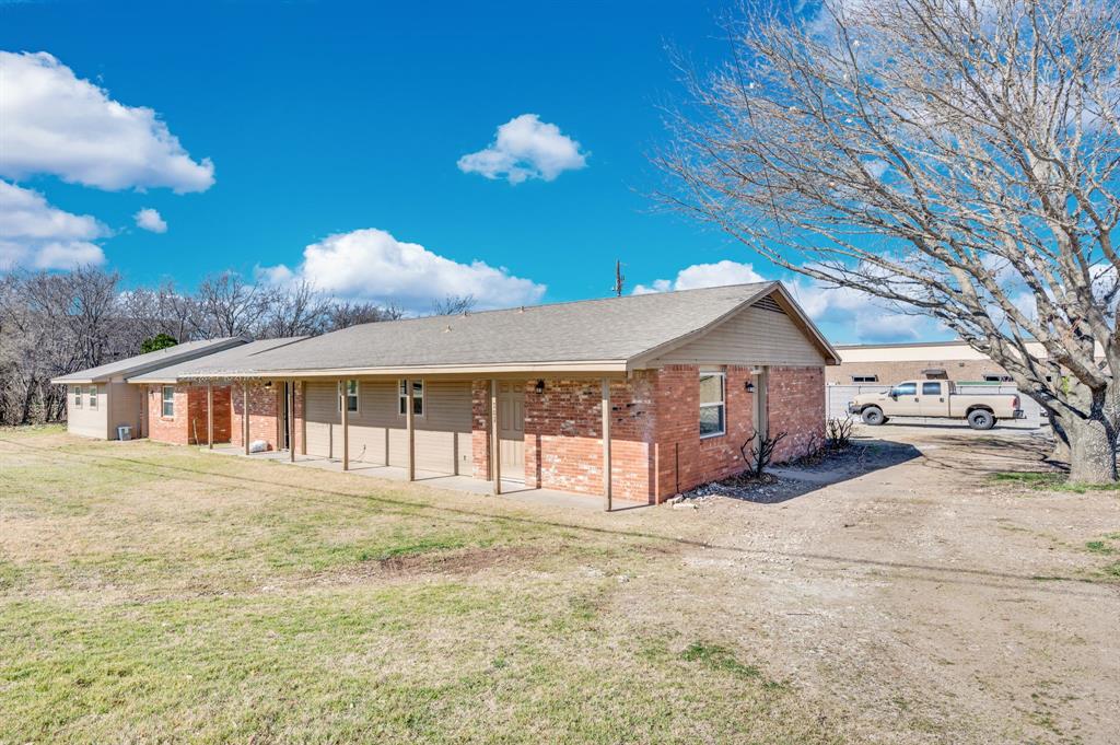 709 George Hopper Road Midlothian, TX 76065 - Photo 14 of 15 a front view of a house with a yard and garage