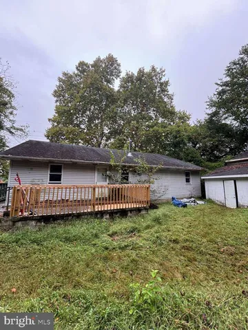 a view of a house with a yard and sitting area