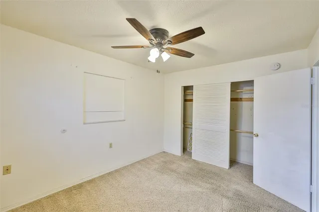 a view of a livingroom with a ceiling fan & a ceiling fan