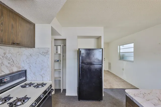a kitchen with a stove and a refrigerator