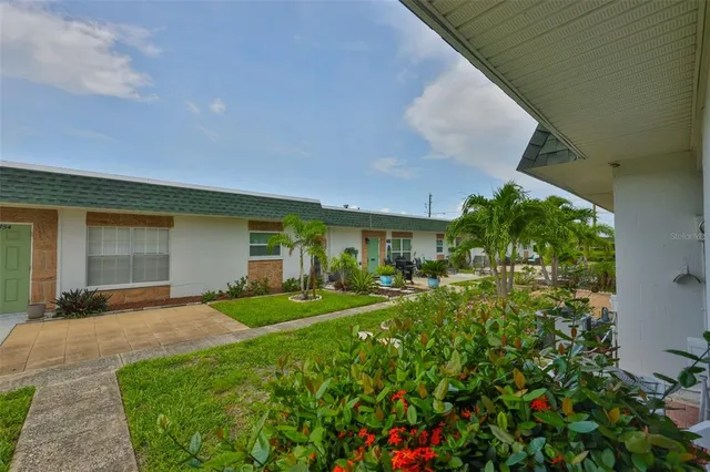 a view of a house with a backyard and porch