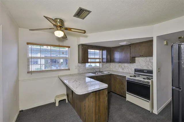a kitchen with a center island and stainless steel appliances