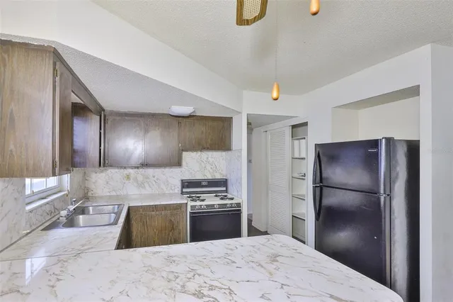 a kitchen with a refrigerator and a sink