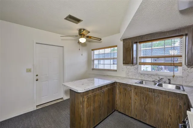 a bathroom with a granite countertop sink mirror and a bathtub