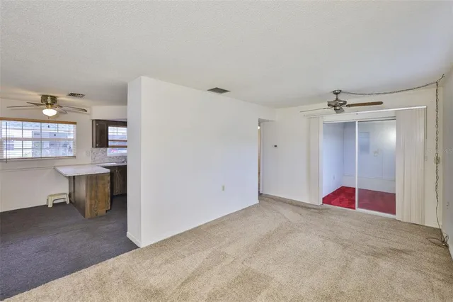 a view of empty room with cabinet and entryway