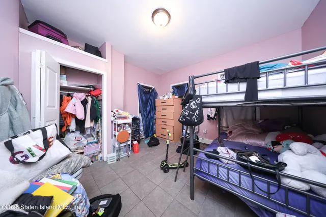 a bedroom with furniture and a closet