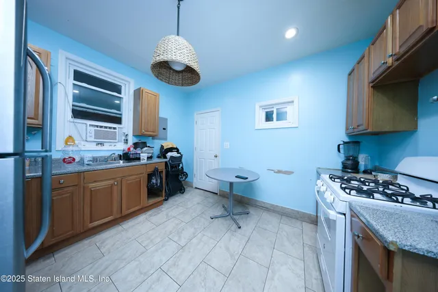 a kitchen with stainless steel appliances granite countertop a sink and cabinets