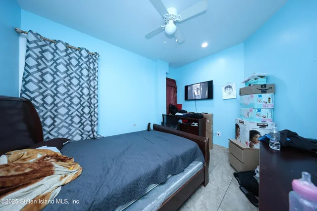 a bedroom with a bed and dresser