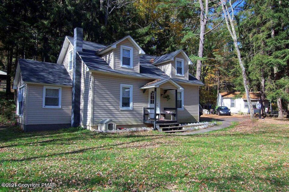 591-601 Pleasant Ridge Road Cresco, PA 18326 - Photo 11 of 16 a front view of a house with garden