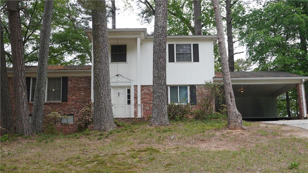 a view of a house with a yard and garage