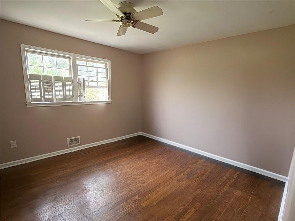 3084 Trafalgar Way Atlanta, GA 30341 - Photo 13 of 31 a view of an empty room with a window and wooden floor