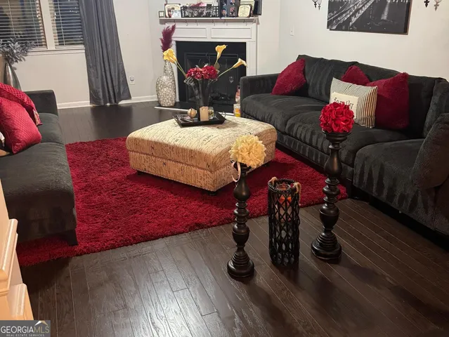 a living room with furniture a couch and a wall painting