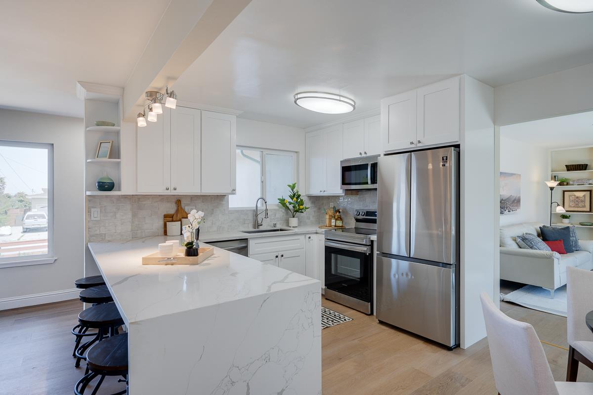490 Jean Circle Marina, CA 93933 - Photo 11 of 60 a kitchen with a refrigerator a sink cabinets and appliances