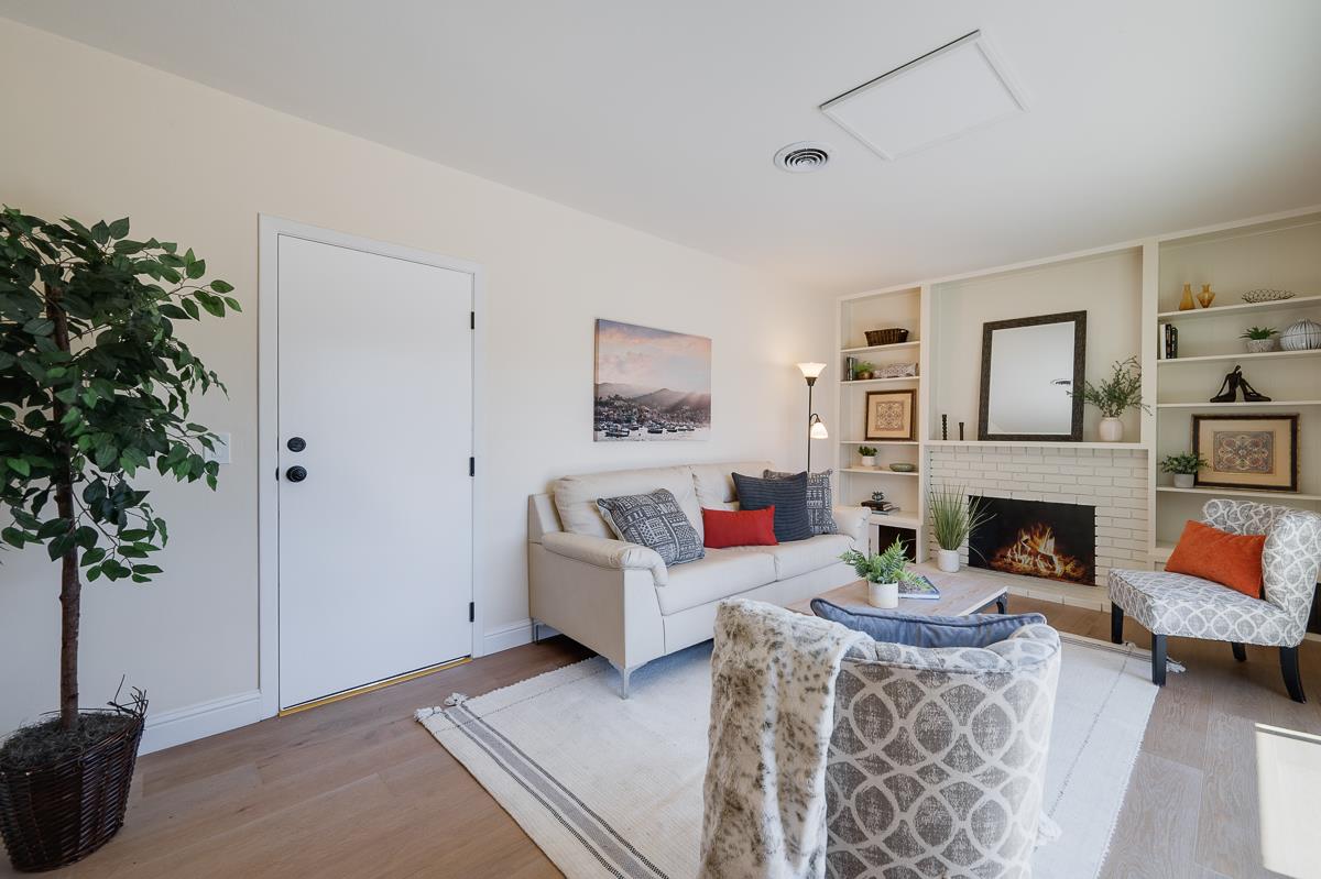 490 Jean Circle Marina, CA 93933 - Photo 21 of 60 a living room with furniture a fireplace and a potted plant