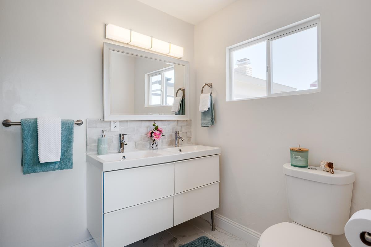 490 Jean Circle Marina, CA 93933 - Photo 30 of 60 a bathroom with a toilet sink and mirror