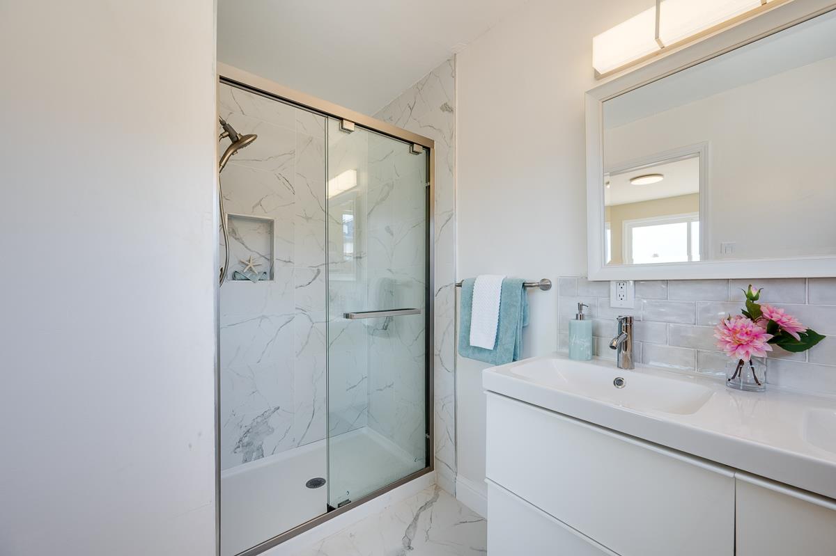 490 Jean Circle Marina, CA 93933 - Photo 31 of 60 a bathroom with a shower sink mirror and vanity