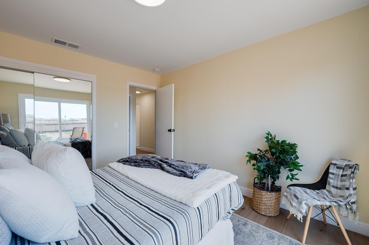 490 Jean Circle Marina, CA 93933 - Photo 36 of 60 a bedroom with a bed and chair table