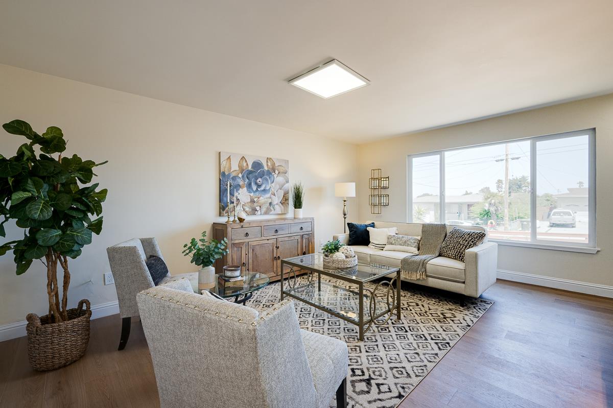 490 Jean Circle Marina, CA 93933 - Photo 5 of 60 a living room with furniture floor to ceiling window and a potted plant