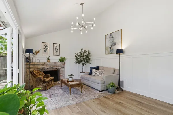 a kitchen with stainless steel appliances a table and chairs in it