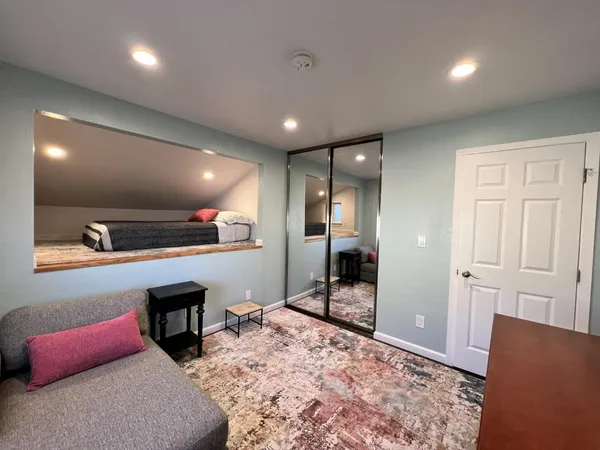 a bathroom with a granite countertop sink mirror vanity and toilet