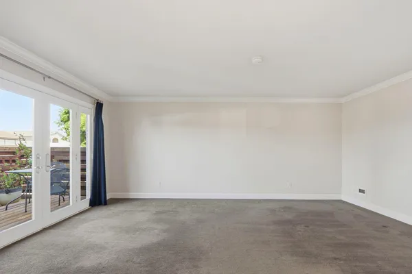 a view of a hallway with wooden floor and entryway