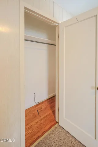 a view of walk in closet with clothes
