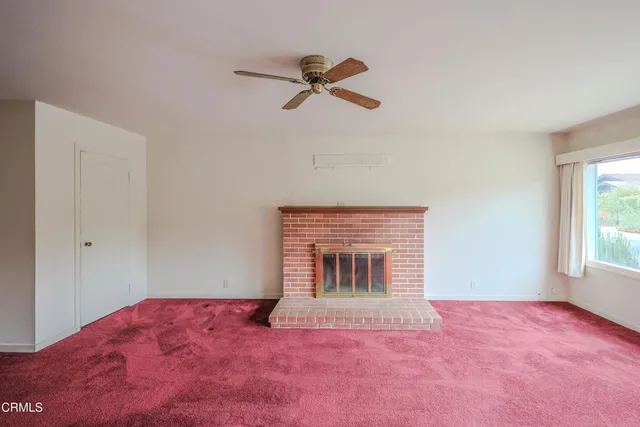 a view of empty room with a fireplace